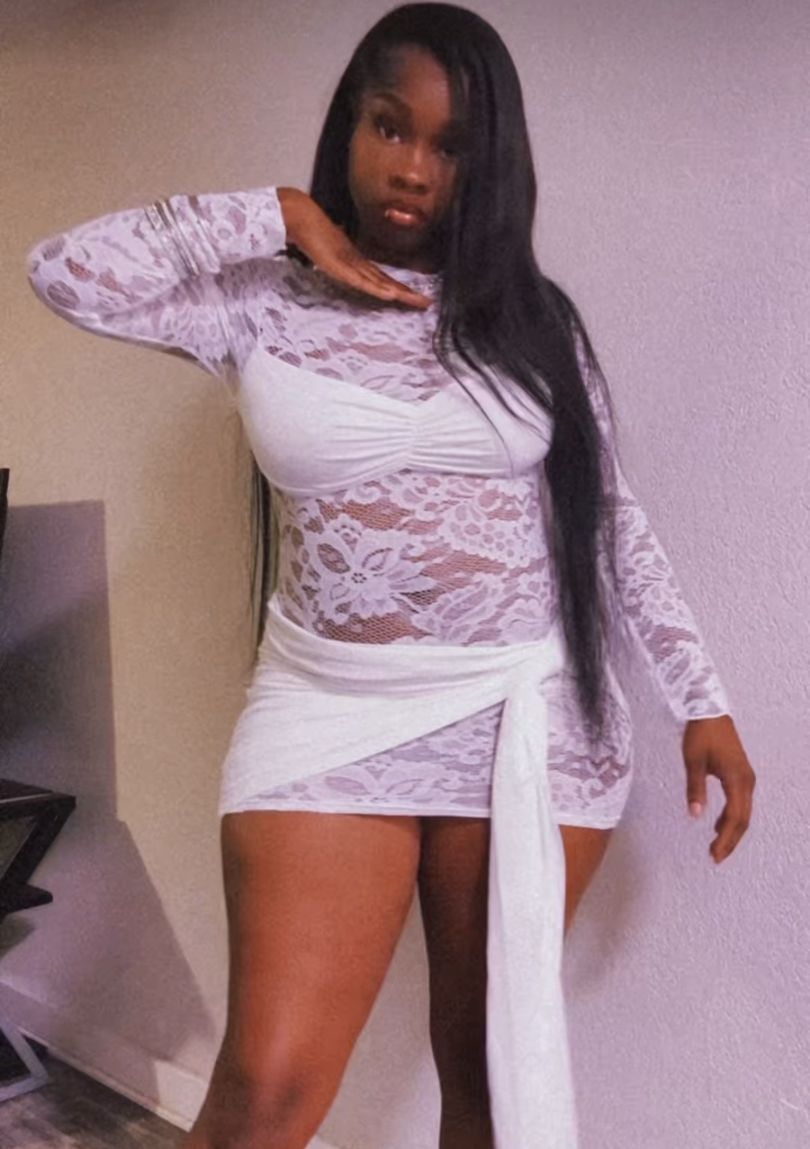 Customer in white lace long-sleeve mini dress